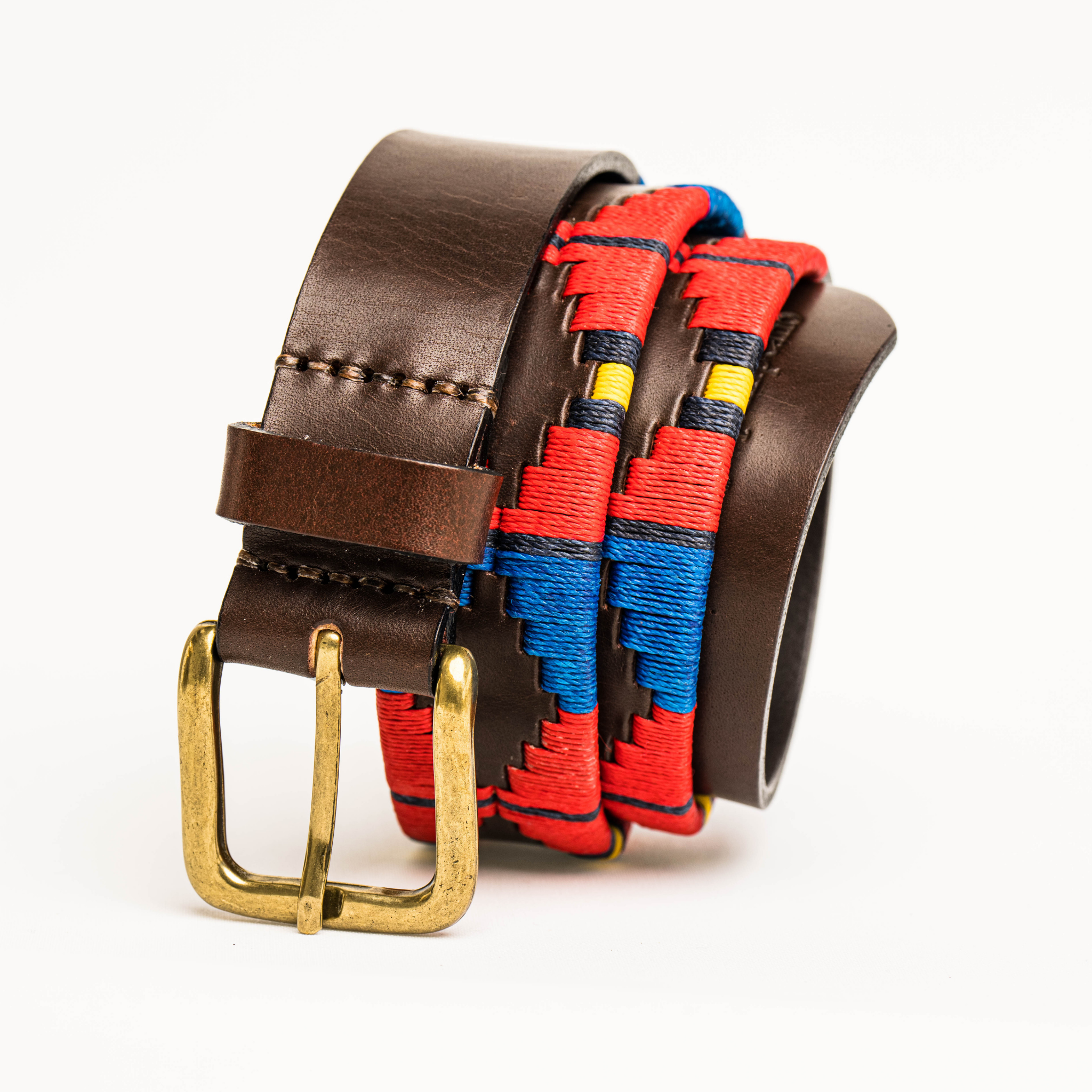 Close-up highlighting the buckle of the Country Direct & Pampeano Royal Artillery Leather Polo Belt, featuring red, blue, and yellow wax thread detailing.